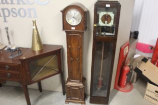 A 1930s oak cased grandmother clock with chiming m