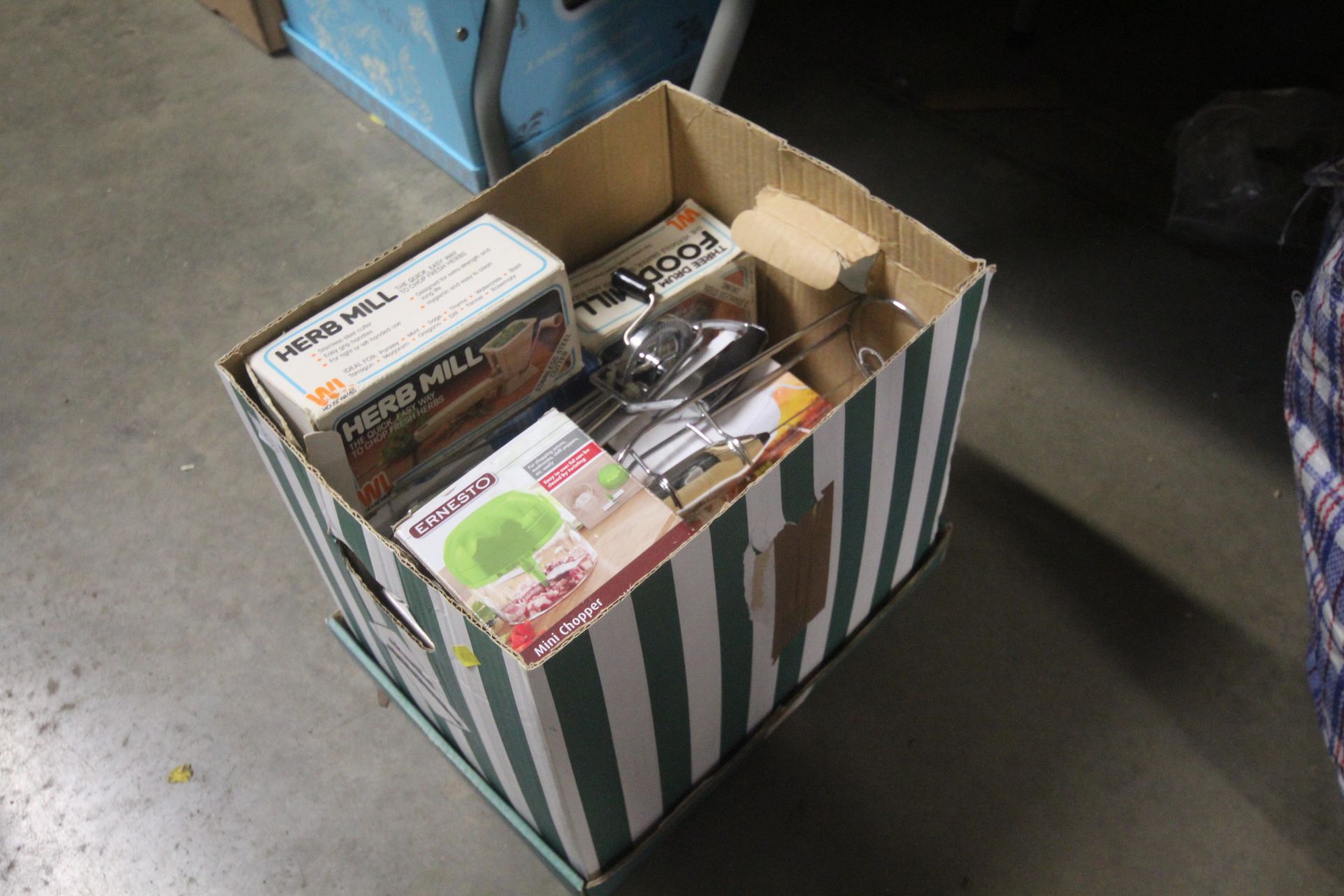 A box of various food mixer items and accessories
