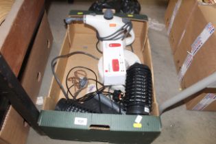 A box containing Vax steam cleaner, roll of cable,