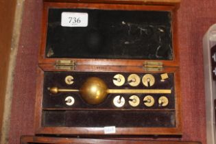 A brass hydrometer in fitted wooden case