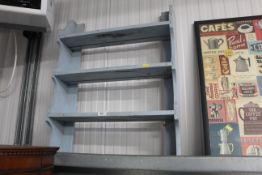 A set of open fronted blue painted wall shelves