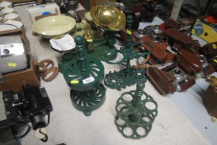 A set of kitchen scales and four iron kitchen stan