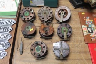 Eight vintage wooden and brass fishing reels