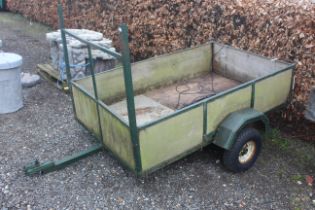 A single axle car trailer with low body wooden sid