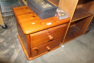 A pine bedside chest fitted two drawers