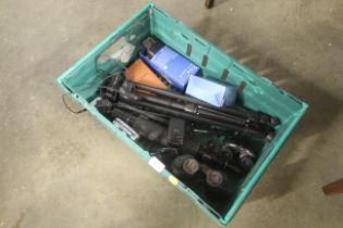 A crate containing binoculars, mobile phones, trip