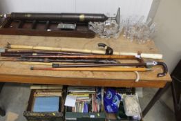 A quantity of various walking sticks, shooting sti