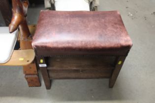 A leather upholstered stool with drop flap compart