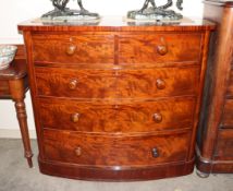 A 19th Century figured mahogany bow front chest of two short and three long drawers fitted turned