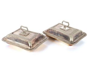 A pair of plated entreé dishes with gadrooned borders