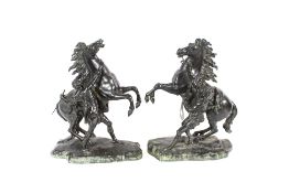 After Cousteau a pair of 19th Century bronze Marley horse and groom figures, 50cm high