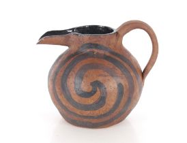 A brown and black glazed Studio pottery baluster water jug, of squat form with swirled decoration,