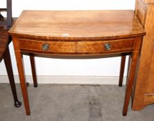 A good quality early 19th Century mahogany bow front fronted side table, having cross banded and