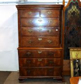 An 18th Century walnut chest on chest, the upper section surmounted by a stepped cornice and