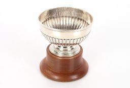 A Victorian silver half fluted bowl, London 1887, 6.5oz, 12.5cm dia. on associated wooden plinth
