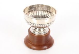 A Victorian silver half fluted bowl, London 1887, 6.5oz, 12.5cm dia. on associated wooden plinth