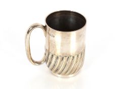 A Victorian silver mug by The Goldsmiths and Silversmiths Company Ltd. with half fluted body
