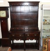 A good quality oak dresser, having boarded and shelved plate rack fitted five short drawers, two