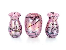 A Loetz, Kralik trailed pink glass vase, 18cm high; and a pair of similar baluster vases 19cm high