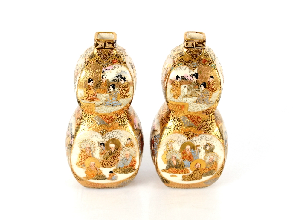 A fine pair of Japanese Satsuma double gourd shaped vases, painted with figures within panels and