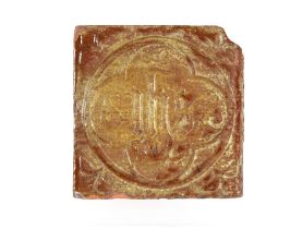 A Medieval period encaustic floor tile with inscription "I.H.S." 11.5cm sq.