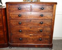 A large Victorian mahogany chest of two short and four long graduated drawers raised on bun feet,