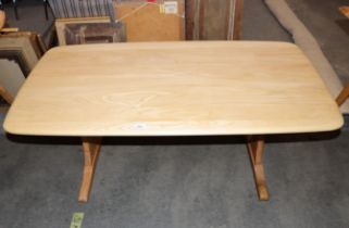 An Ercol coffee table, raised on shaped end supports, 126cm wide x 68cm deep x 52cm high