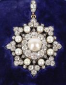 A fine and impressive diamond and pearl star pendant / brooch. The pendant set central pearl 9mm