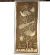 A framed and glazed silvered thread embroidery, depicting peacocks, pheasants and flowers on a