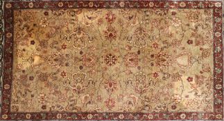 A small Persian silk rug, having central field of flowers and birds within similar multi borders,