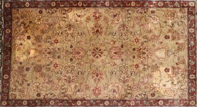 A small Persian silk rug, having central field of flowers and birds within similar multi borders,