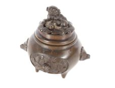 A 19th Century Oriental bronze censer and cover, decorated with panels of birds, the cover with Fo