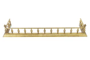 An ornate brass fender, 135cm long