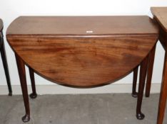 A mid 18th Century mahogany drop leaf dining table, raised on rounded tapering supports