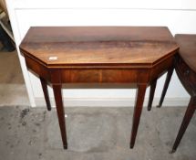A late 18th Century mahogany and satin wood strung fold over card table, the canted top raised on
