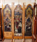 A 19th Century and later three section stained glass screen, in Gothic style golden oak frames