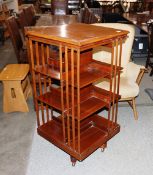 A large late 19th / early 20th Century mahogany four tier revolving bookcase in the Maples style,