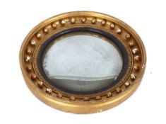 A 19th Century circular gilt convex wall mirror, with ball decoration, 47cm dia.