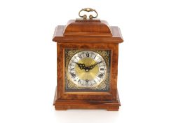 A mid-20th Century walnut cased chiming mantel clock, in the early Georgian style, brass and steel
