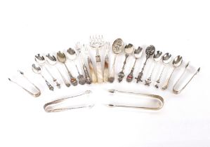 Two pairs of silver sugar tongs; various silver  and white metal spoons; pickle fork etc.