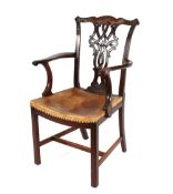 A set of six mahogany dining chairs, in the Chippendale style having foliate carved cresting