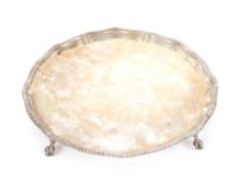 A silver salver by The Goldsmiths and Silversmiths Company, having pie crust gadrooned border raised