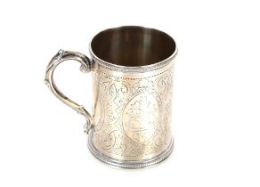 A Victorian silver mug, with all over foliate decoration, date letter rubbed but probably London