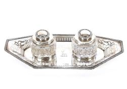 A late Victorian silver inkstand of elongated octagonal shape with pierced gadrooned border, cut
