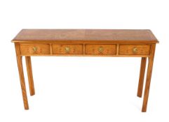 A burr oak and cross banded four drawer hall table, raised on square section chamfered supports,
