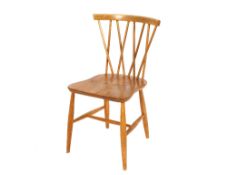 A set of four Ercol stick back kitchen chairs, raised on rounded supports united by H stretchers