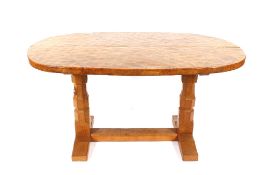 Workshop of Robert "Mouseman" Thompson of Kilburn, an oval English oak dining table with adzed