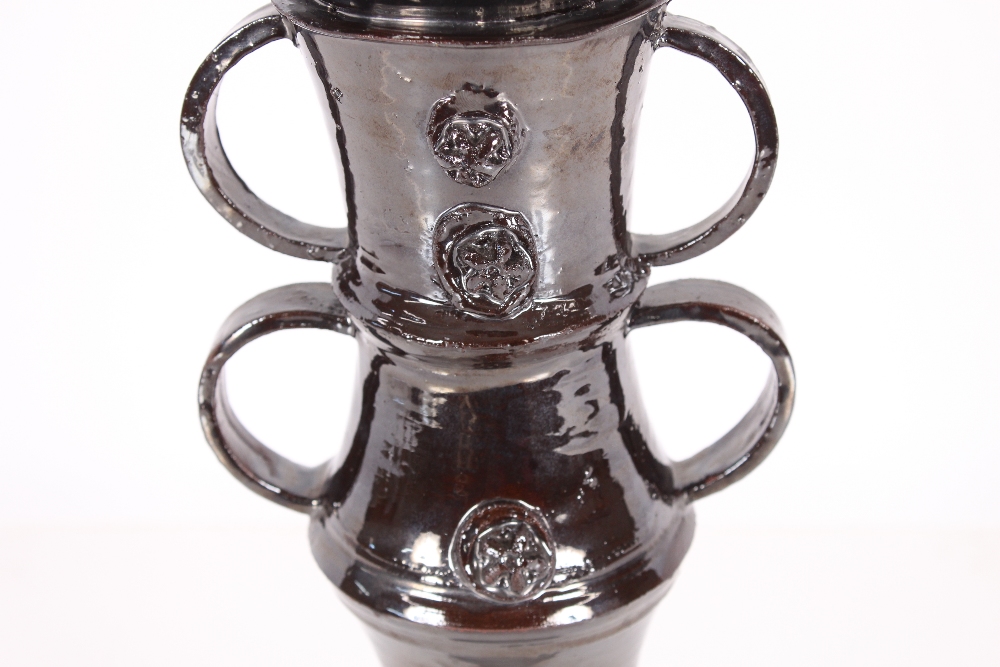 A dark lustre glazed Studio pottery candlestick, with ring handles and raised decoration, 33cm high - Bild 3 aus 4