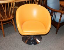 A modern design orange leatherette upholstered swivel tub chair on circular chrome base