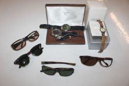 A collection of wrist watches and sun glasses